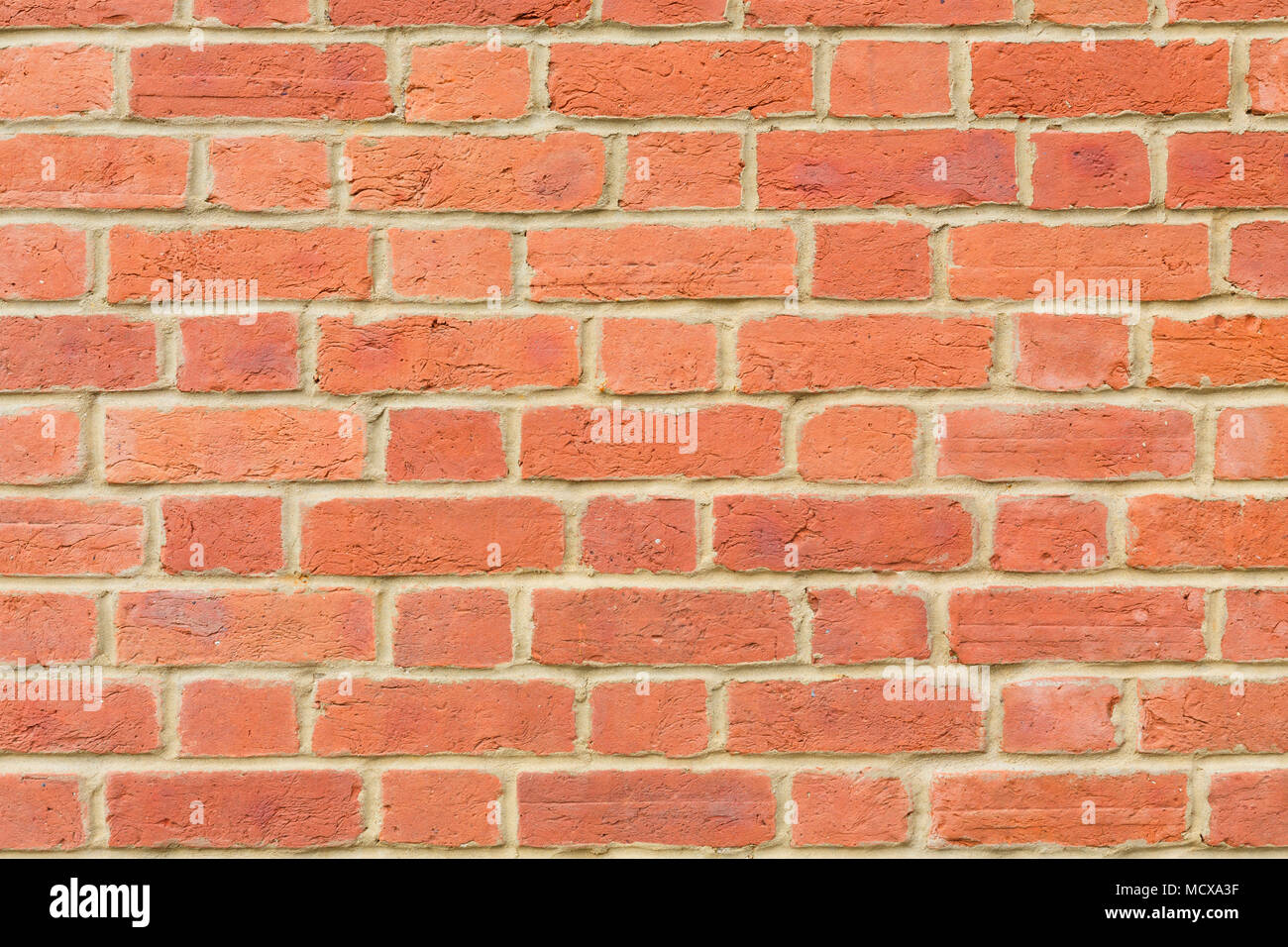 Red brick wall background closeup pointed with lime mortar Stock Photo