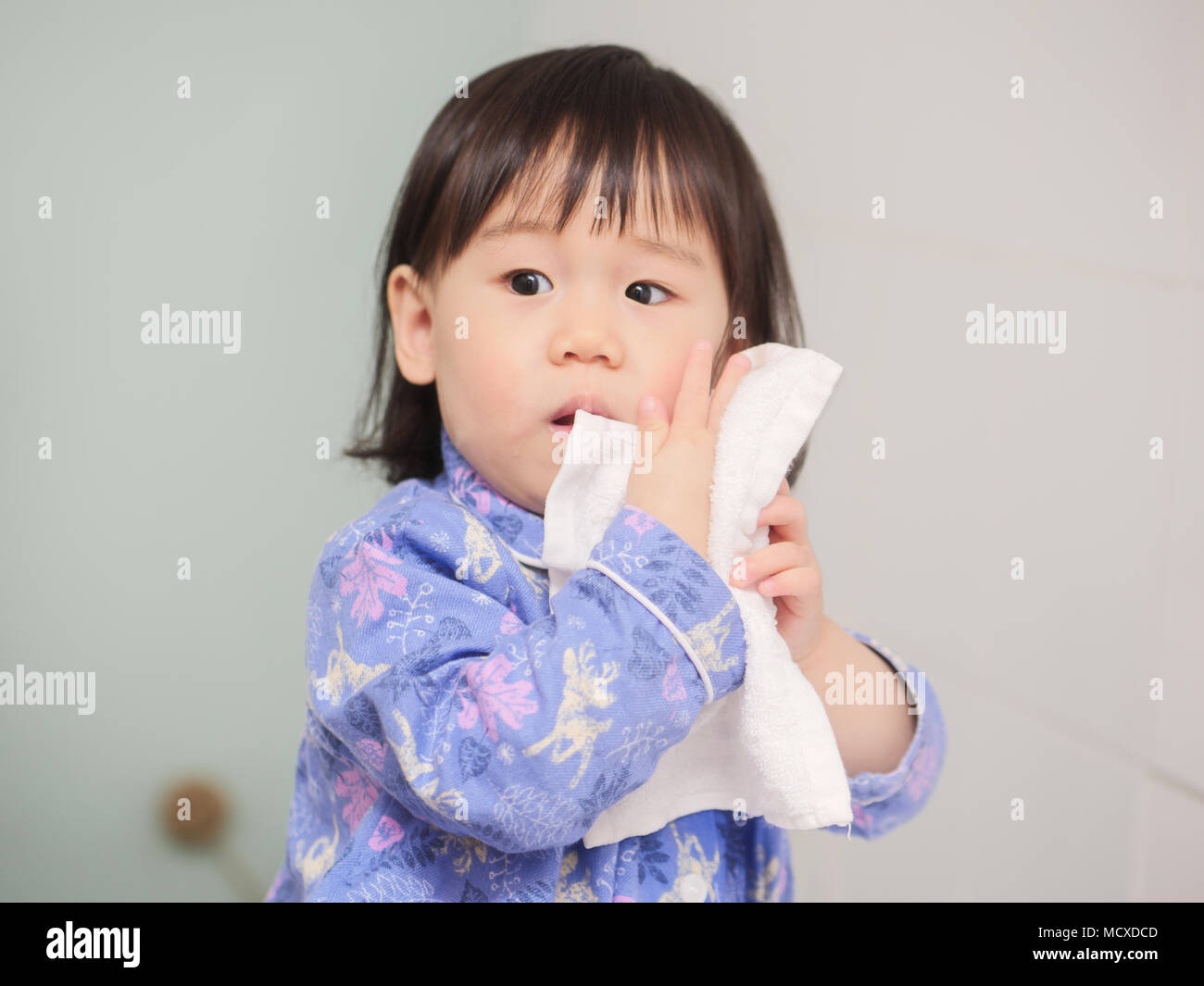 baby girl washing face by herself Stock Photo Alamy