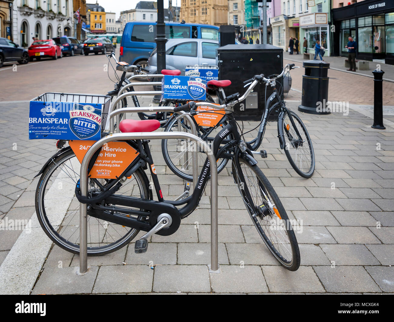 Donkey bikes chained to bike posts in Cirencester's town centre ready