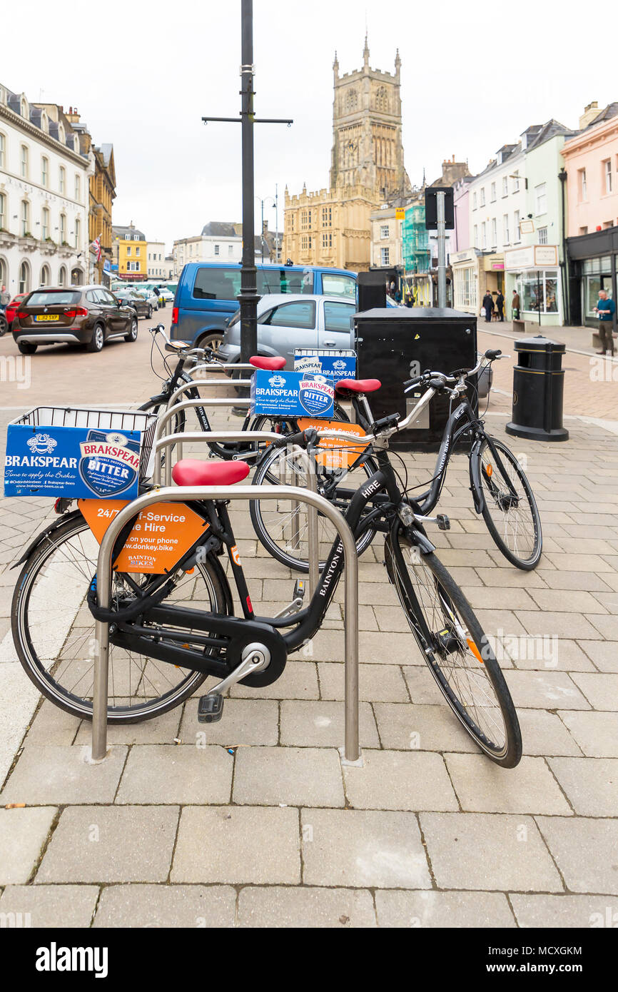Donkey bikes chained to bike posts in Cirencester's town centre ready