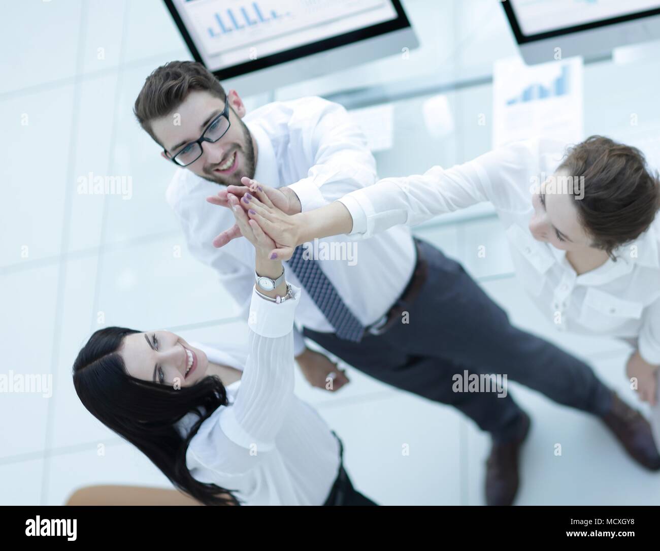 successful business team giving each other a high five Stock Photo - Alamy