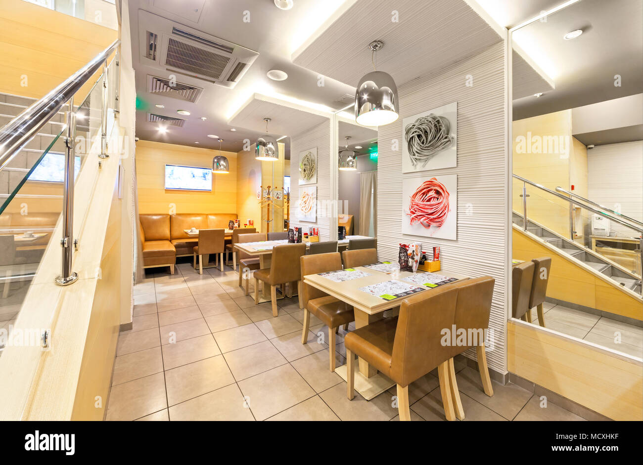MOSCOW - AUGUST 2014: The interior of chain cafe pan-Asian cuisine - 'Menza'. The tables with chairs without visitors Stock Photo