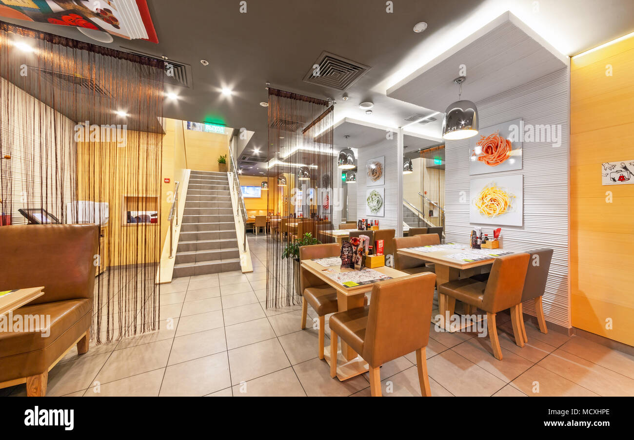 MOSCOW - AUGUST 2014: The interior of chain cafe pan-Asian cuisine - 'Menza'. The tables with chairs without visitors Stock Photo
