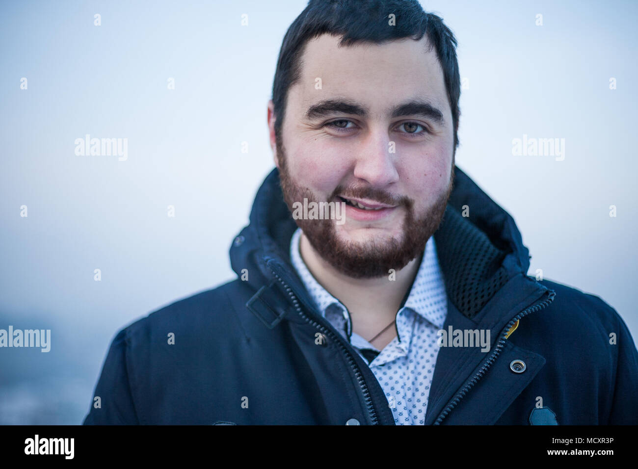 Portrait of a young brutal sarcastic man looking at camera Stock Photo