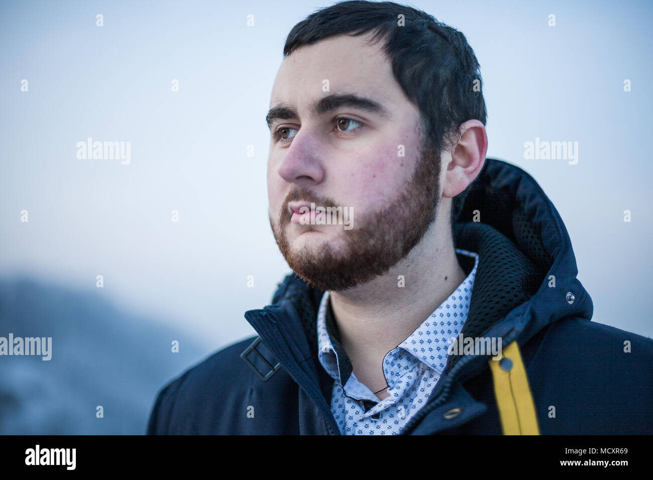 Portrait of a young thoughtful bearded brutal man Stock Photo