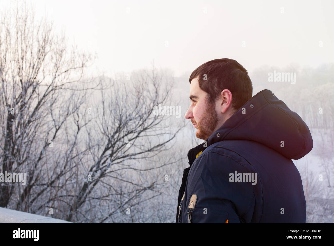 Hipster man traveler against winter landscape Stock Photo