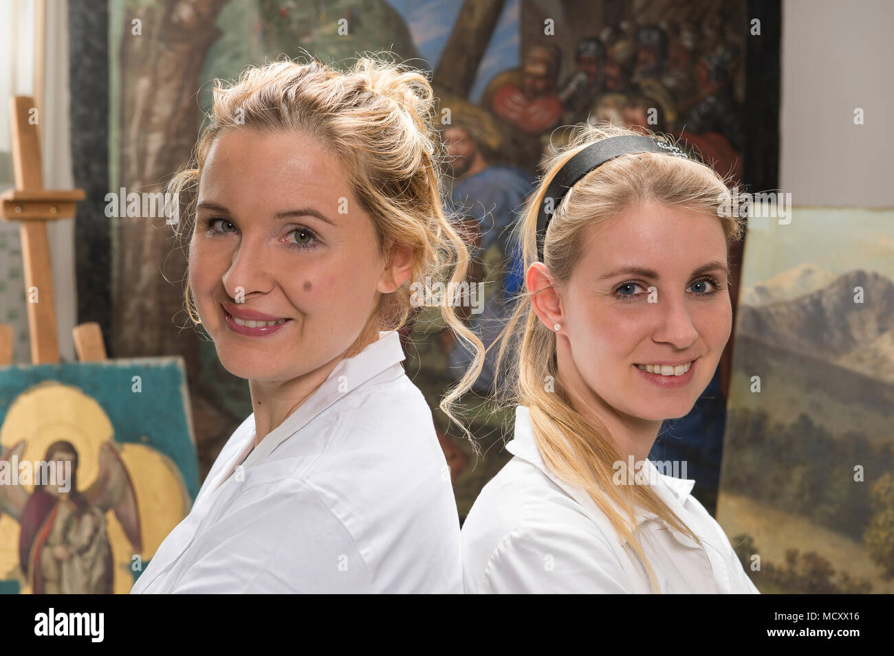 Restoration atelier,Women, Restorers stand in front of restored Lent Scarf, Munich, Bavaria, Germany Stock Photo