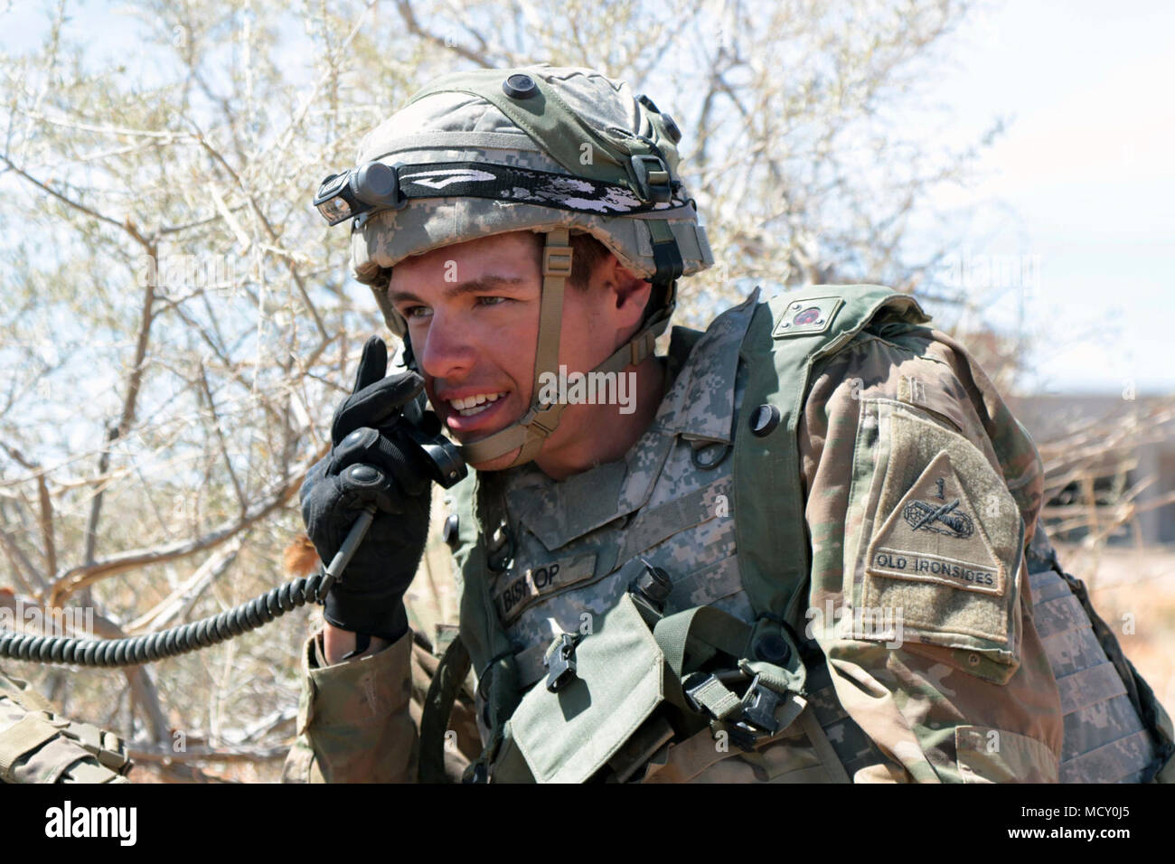 OROGRANDE, New Mexico - Pfc. Kaleb Bishop, a fire support specialist with 2nd Battalion, 3rd Field Artillery Regiment, 1st Brigade Combat Team, 1st Armored Division, reports his observation to his squad leader during Iron Focus 18.1 field training exercise here March 22, 2018. Iron Focus 18.1 FTX is designed to prepare 3rd Armored Brigade Combat Team, 1st Armored Division, for National Training Center rotation 18-08, and it enables the commander to focus leadership, training and resources on improving 3rd ABCT’s combat readiness to meet future contingency requirements. Stock Photo