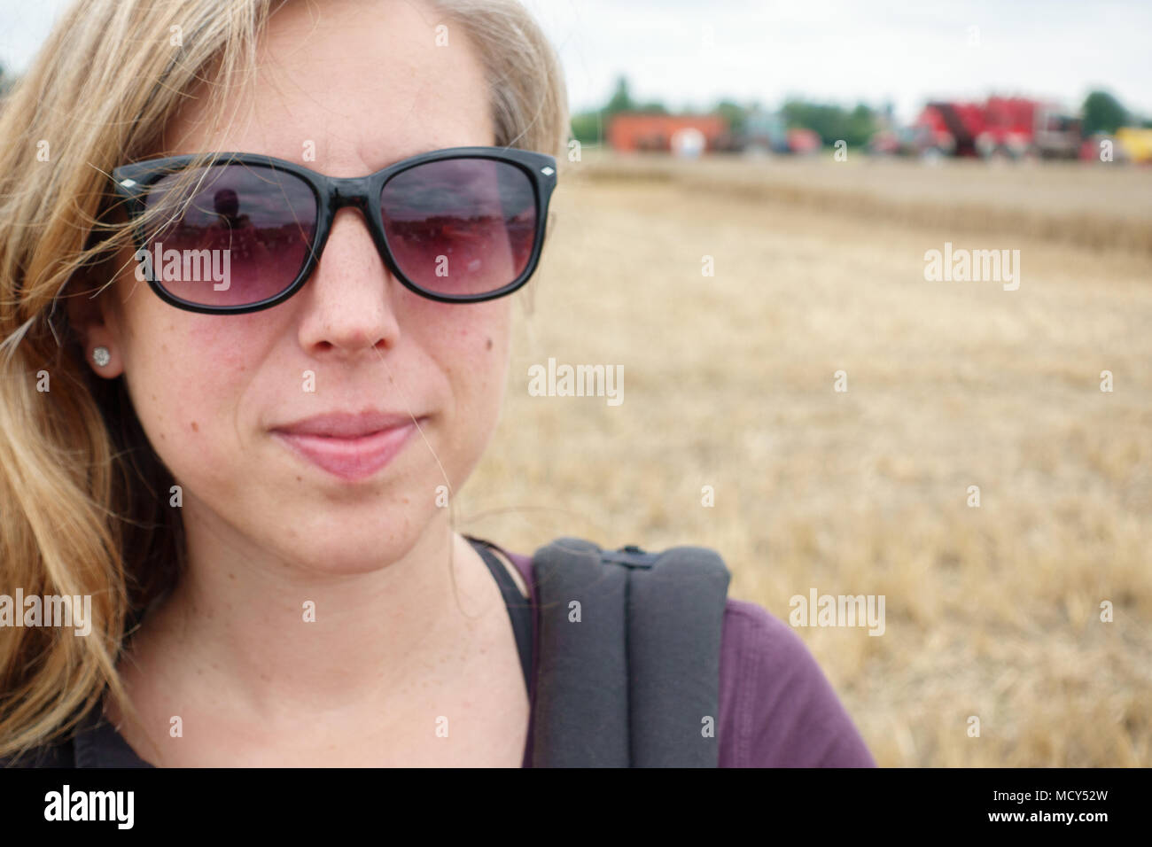 Portrait of young woman with rural field Stock Photo