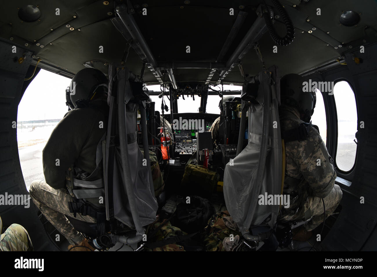 N.Y. Army National Guard Soldiers with 3rd Battalion, 142nd Aviation, sit in a UH-60 Black Hawk Helicopter, at the Army Aviation Facility 3, Latham, N.Y., March 3rd, 2018. The 3-142nd was conducting air assault training. (N.Y. National Guard photo by Spc. Andrew Valenza) Stock Photo