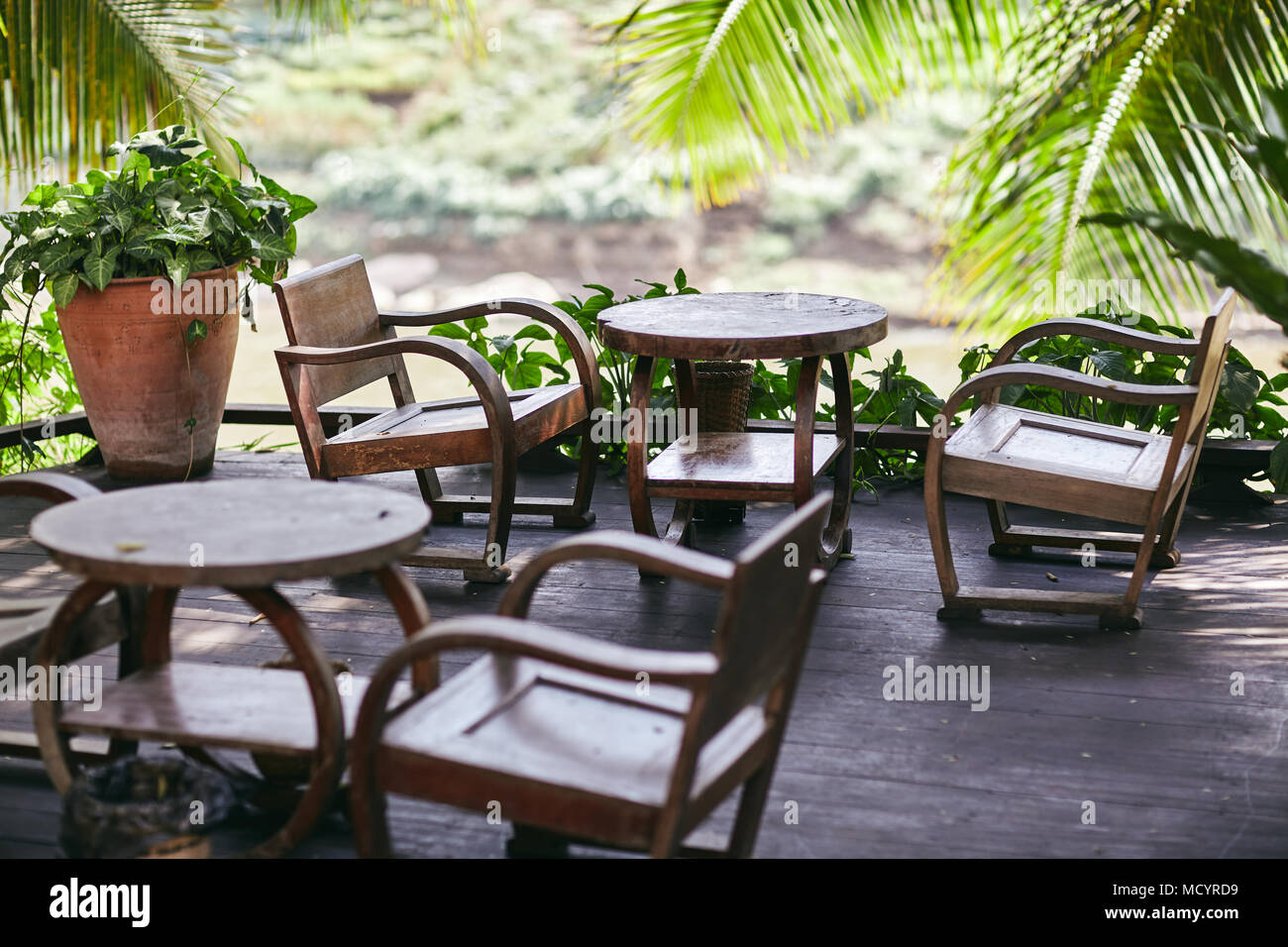 The old table in restaurant nearby Mekong river for breankfast and coffee time to enjoy the atmosphere of simple life in Luang Phrabang Stock Photo