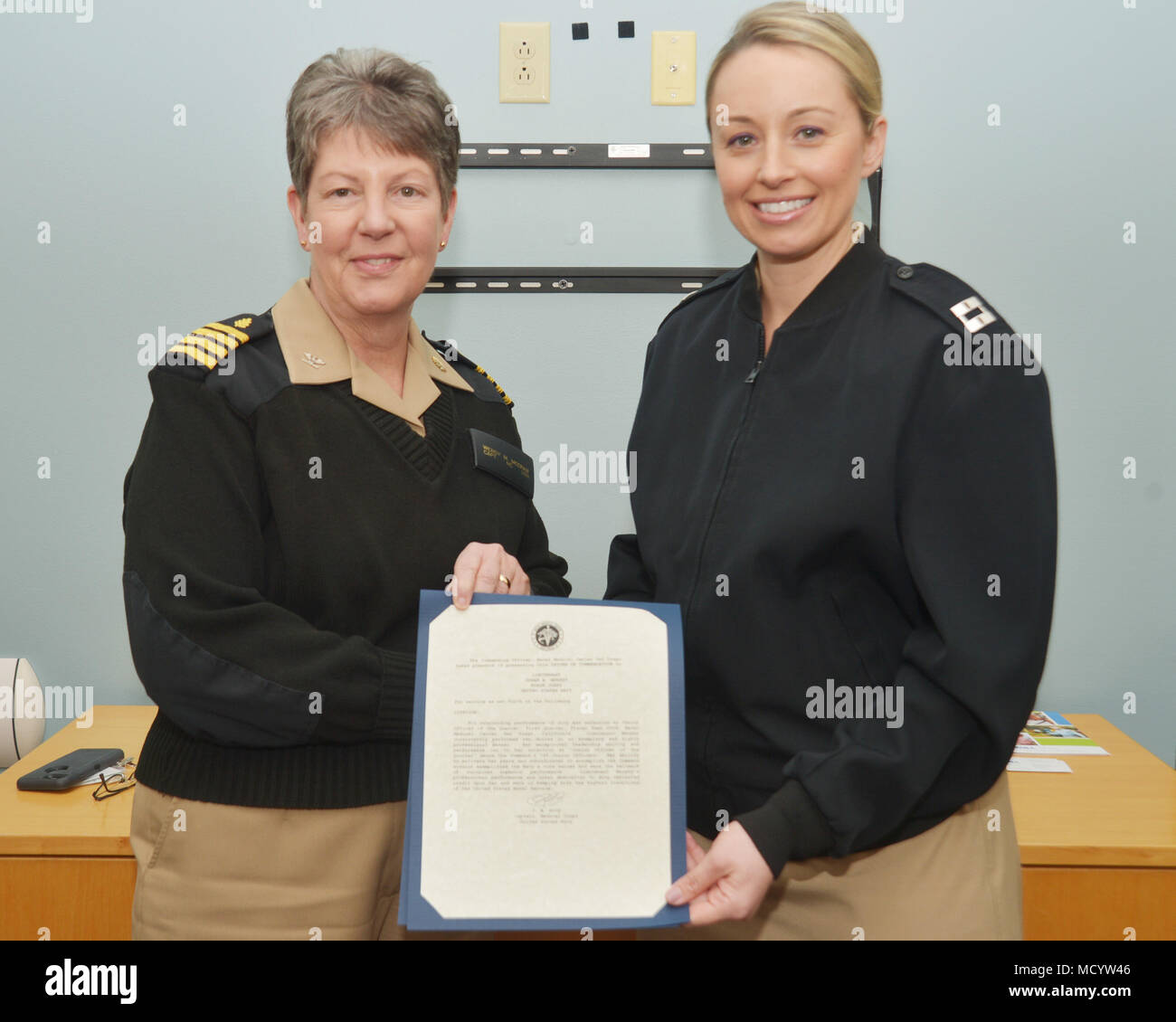 180307-N-PN275-1002 SAN DIEGO (March 02, 2018) Lt. Susan Murphy, right, assigned to Naval Medical Center San Diego(NMCSD), receives the Junior Officer of the Quarter award from Capt. Wendy McCraw. Lt. Murphy received the award for her leadership and work ethic while managing the NMCSD Intensive Care Unit, (U.S. Navy Photo by Mass Communication Specialist 2nd Class Zach Kreitzer/Released) Stock Photo