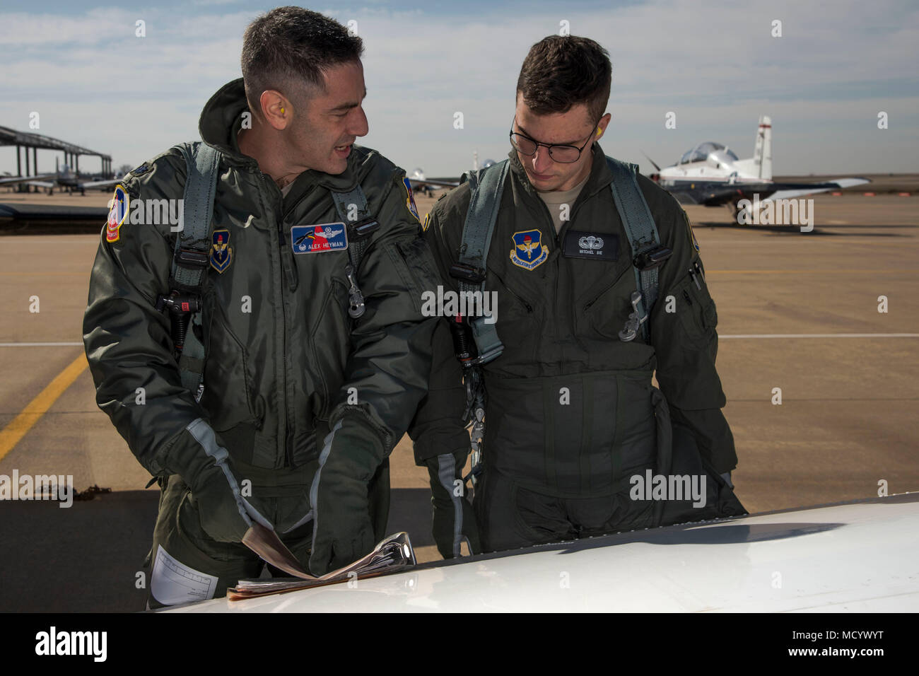 Lt. Col. Alexander Heyman, Commander, 71st Student Squadron, goes over the pre-flight checklist with 2nd Lt. Mitchel Bie, a student pilot at Vance, before Bie's 'Dollar Ride', March 8, 2018, Vance Air Force Base, Okla. Heyman and Bie went to the same highschool: Sycamore High School, Cincinnati, Ohio. (U.S. Air Force photo by Airman Zachary Heal) Stock Photo
