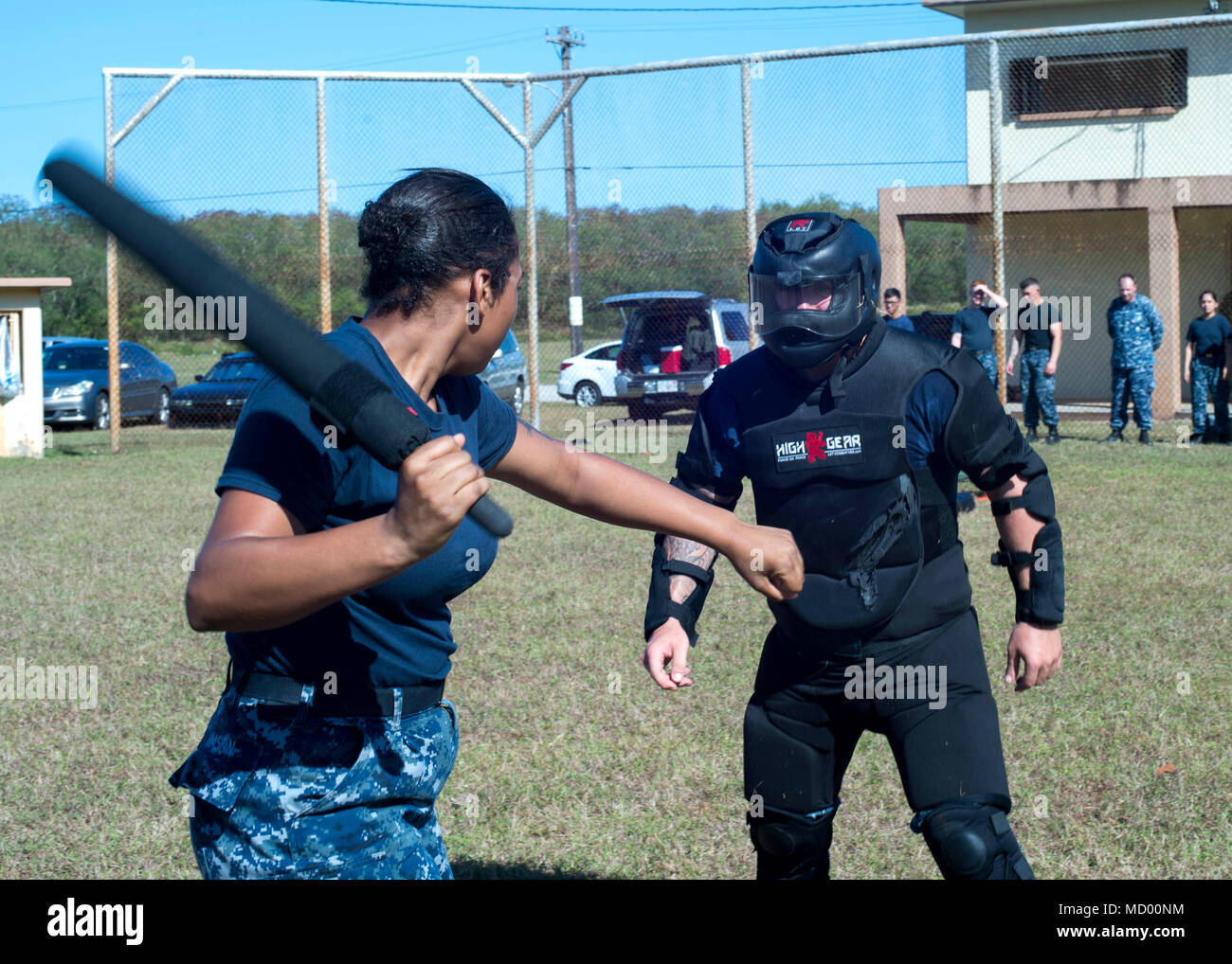 SANTA RITA, Guam ( March 9, 2018) Boatswain's Mate 3rd Class Jazlen Mason battles Red Man, Gunner's Mate Seaman Blake day, both assigned to the submarine tender USS Frank Cable (AS 40), during non-lethal weapons training, while under the effects of Oleoresin Capsicum, pepper spray, on Naval Base Guam, March 9. Frank Cable, forward-deployed to Guam, repairs, rearms and reprovisions deployed U.S. Naval Forces in the Indo-Pacific region.   (U.S. Navy photo by Mass Communication Specialist 3rd Class Alana Langdon/Released) Stock Photo
