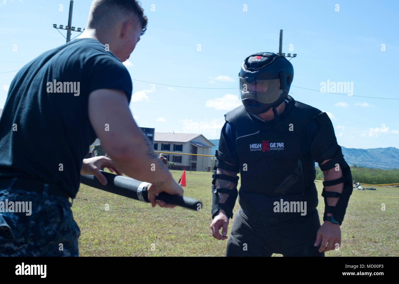 SANTA RITA, Guam ( March 9, 2018) Gunner's Mate Seaman Michael White approaches Red Man, Gunner's Mate Seaman Blake Day, both assigned to the submarine tender USS Frank Cable (AS 40), as he fights through stations during non-lethal weapons training, while under the effects of Oleoresin Capsicum, pepper spray, on Naval Base Guam, March 9. Frank Cable, forward-deployed to Guam, repairs, rearms and reprovisions deployed U.S. Naval Forces in the Indo-Pacific region.   (U.S. Navy photo by Mass Communication Specialist 3rd Class Alana Langdon/Released) Stock Photo
