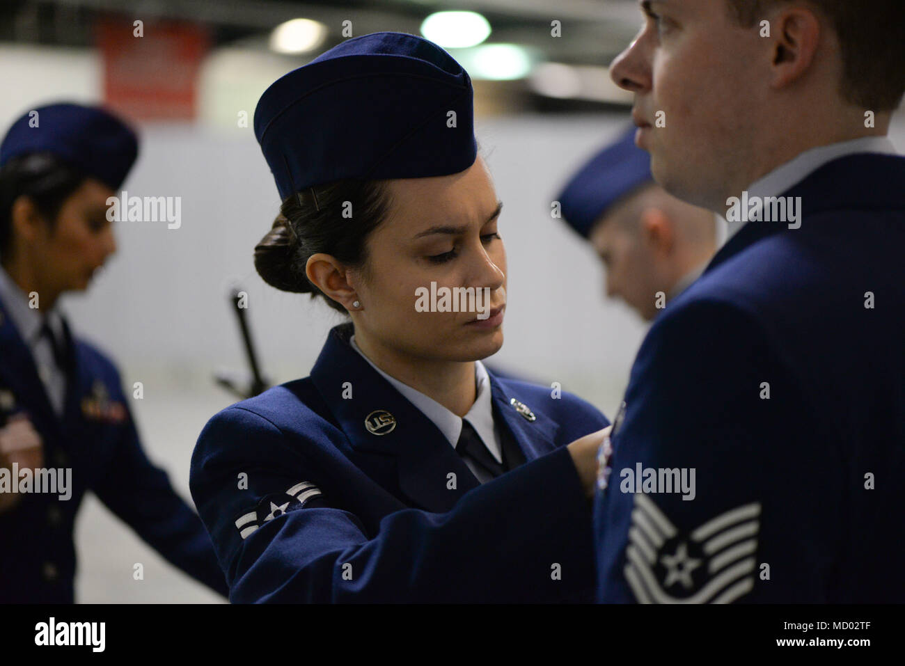 U.S. Air Force Airman 1st Class Jessica Farkas, a public health technician  assigned to the 181st Medical Group, inspects a drill team member's uniform  at Camp Atterbury, Ind., Mar. 3, 2018. Farkas