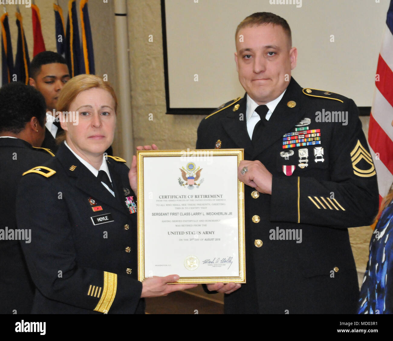Sgt. 1st Class Larry Weckherlin receives his certificate of retirement from Brig. Gen. Heidi Hoyle during the Rock Island Arsenal Retirement and Retreat Ceremony, March 8. (Photo by: Tony Lopez, JMC Public and Congressional Affairs) Stock Photo