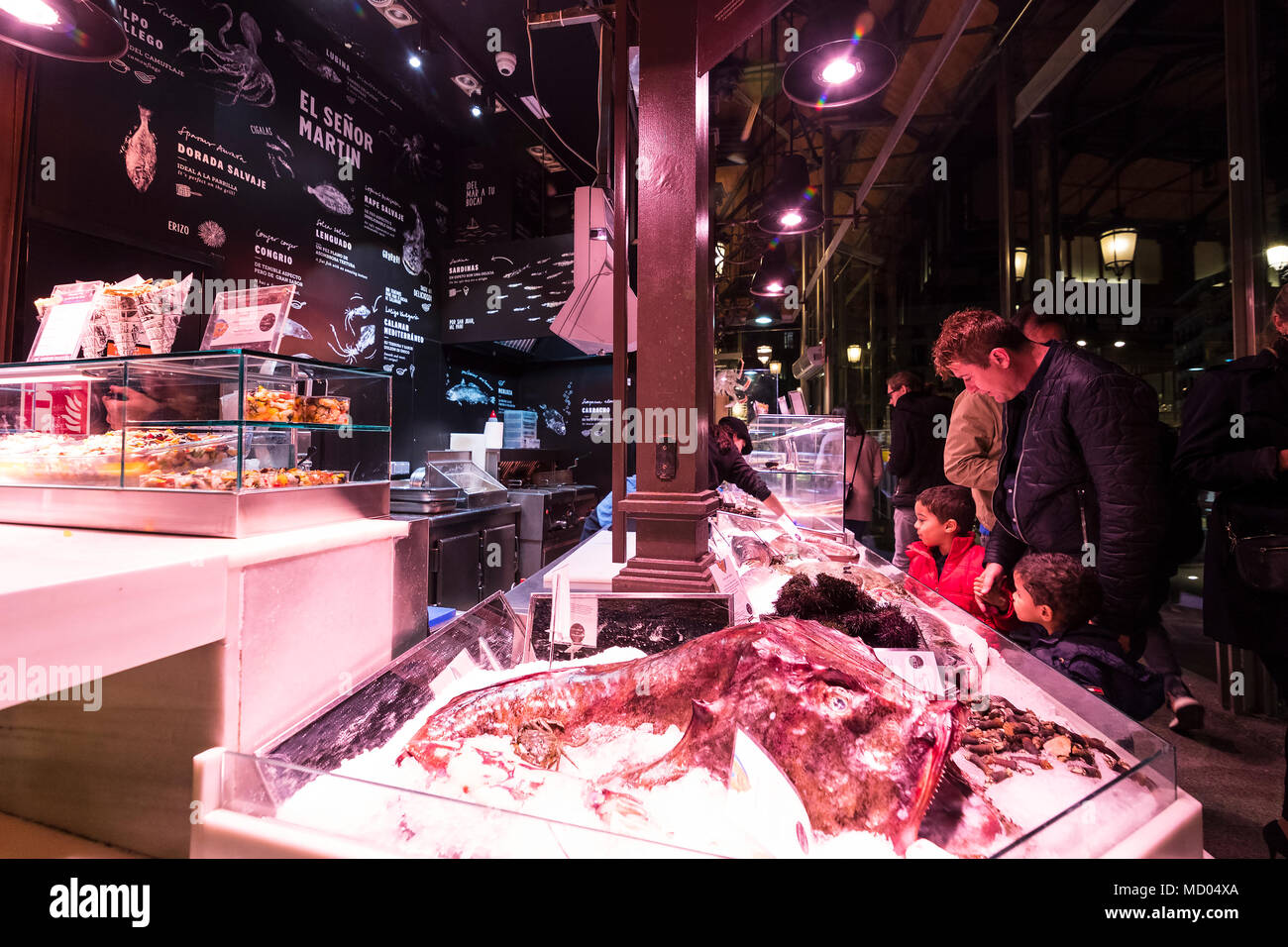 MADRID, SPAIN - 28 MARCH, 2018: Evening market of San Miguel serving customers. Stock Photo