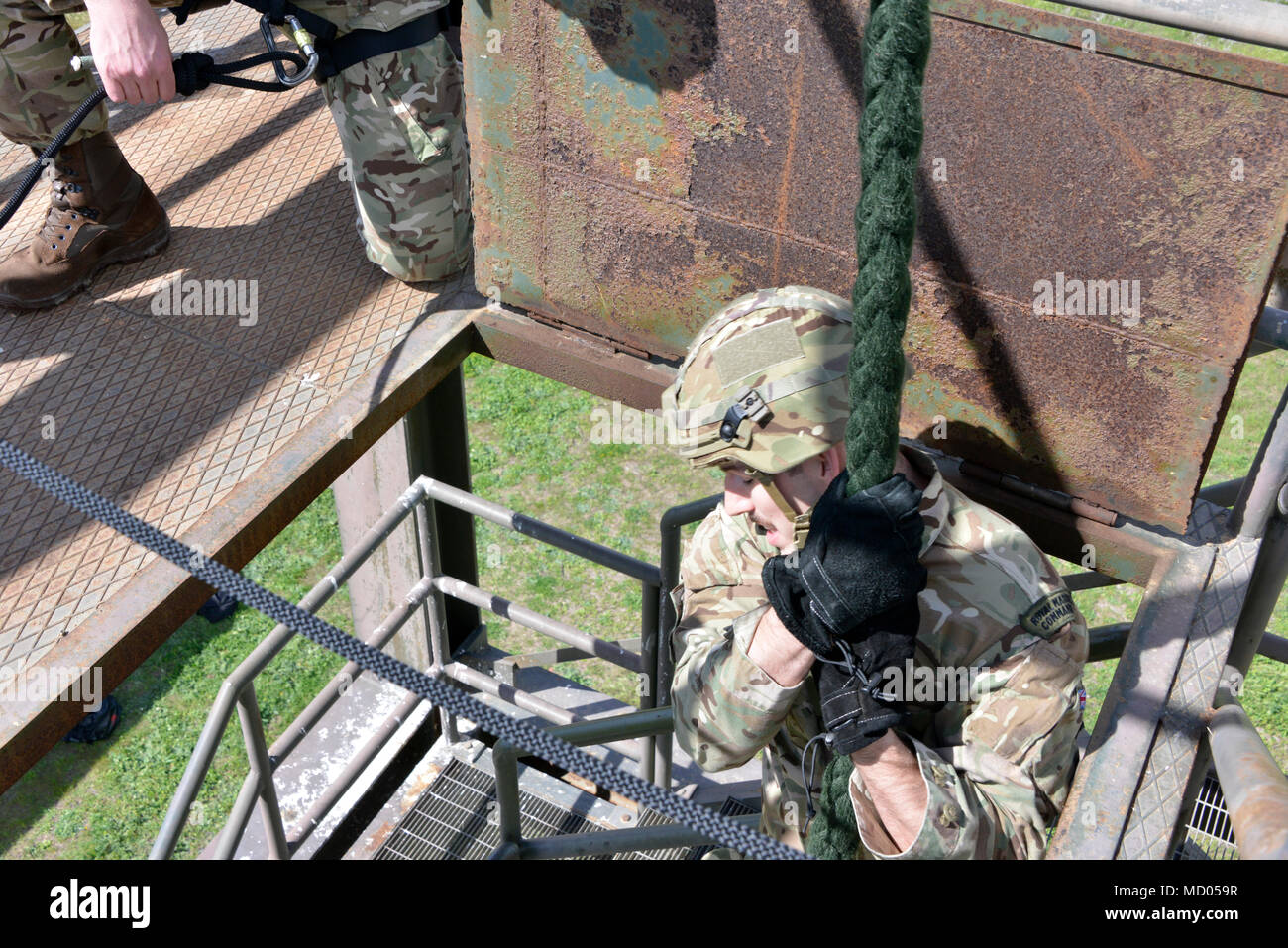 A British Royal Marine commando fast ropes during a training exercise ...