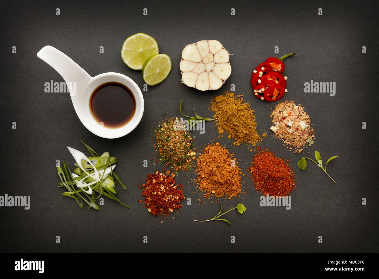 Hot and spicy ingredients to make delicious hot and tasty food, on a dark slate background. Stock Photo