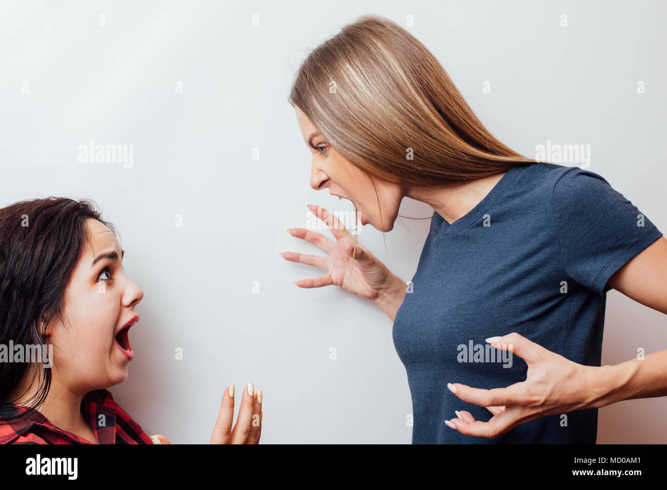 Screaming, hate, rage.  Emotional, young face. Female half-length portrait. Human emotions, facial expression concept. Stock Photo