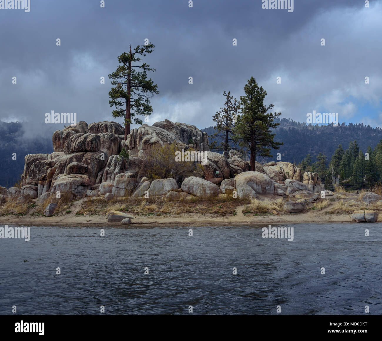A mountain storm rolls in over a boulder island in the California Mountains Stock Photo