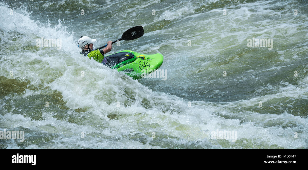 Young kayaker navigating the whitewater of the Chattahoochee River in Columbus, Georgia. (USA) Stock Photo