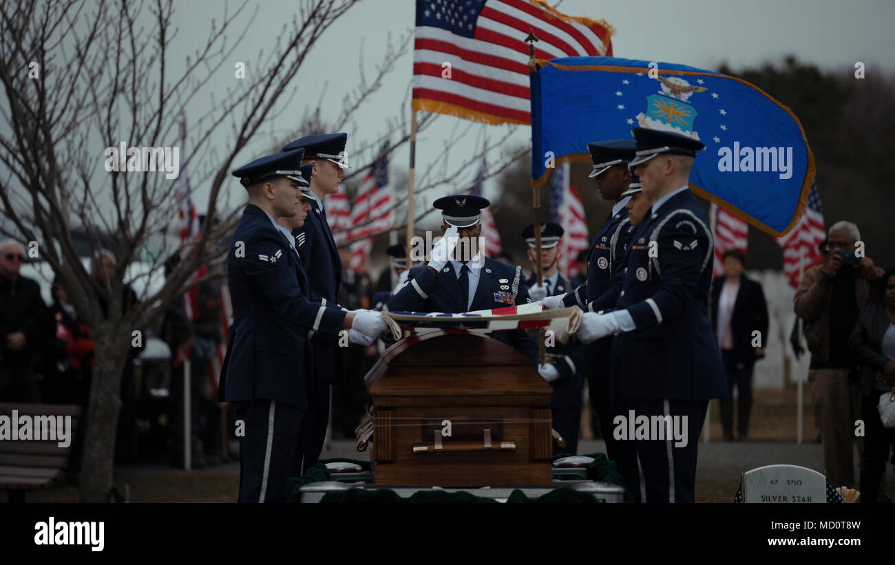 Base Honor Guard Airmen from Joint Base McGuire-Dix-Lakehurst, New Jersey, render honors for Tech. Sgt. Dashan Briggs, a special missions aviation specialist assigned to the 106th Rescue Wing, New York Air National Guard, during a funeral service at Calverton National Cemetery, N.Y., March 29, 2018. Briggs was killed when the HH-60G Pave Hawk helicopter he was flying in crashed near the city of Al-Qa’im, Iraq. Stock Photo