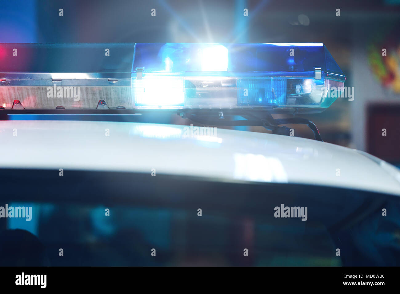 Blue siren flasher on the police car at night. Siren on police car