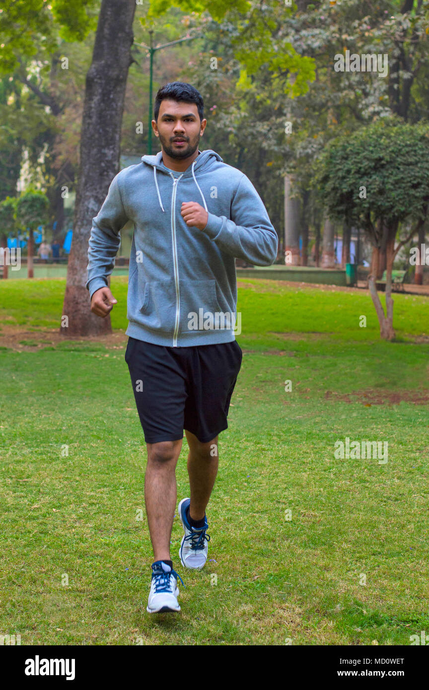 Young guy jogging in a park Stock Photo
