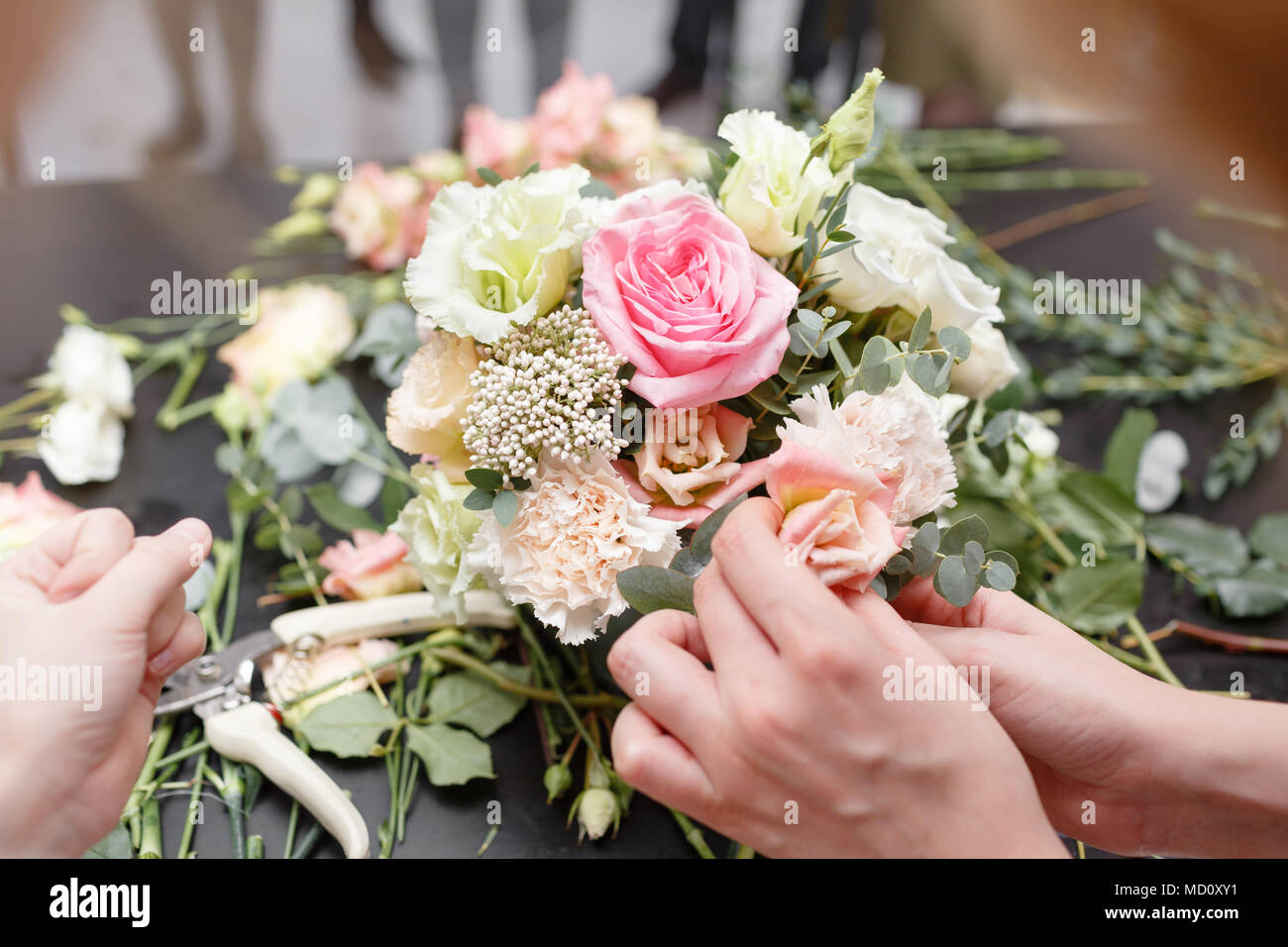 Master class on making bouquets for kids. Spring bouquet in metal ornamental flowerpot. Learning flower arranging, making beautiful bouquets with your own hands Stock Photo