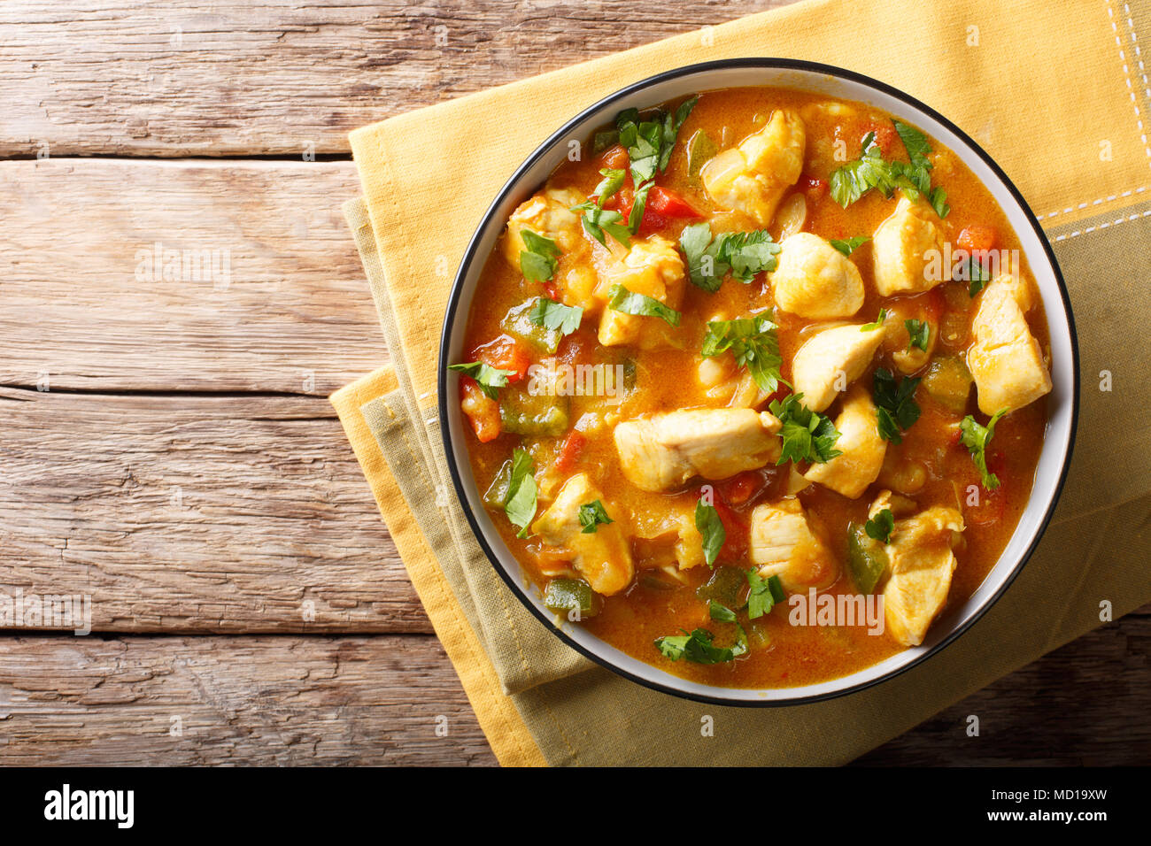 Bobo chicken with vegetables in coconut milk close-up in a bowl on the table. Horizontal top view from above Stock Photo