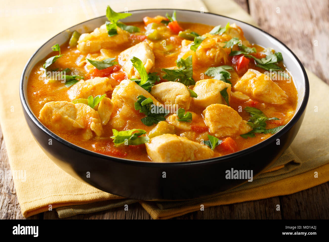 Bobo chicken stew with yuca, onion and pepper in coconut milk close-up in a bowl on the table. horizontal Stock Photo