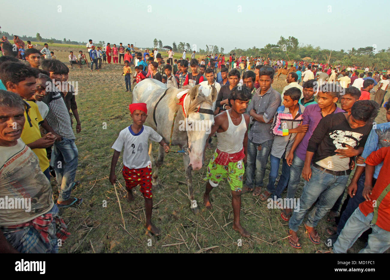 Mathurapur, India. 16th Apr, 2018. Villagers gathered to see the horse during Rural Horse race in annual Baisakhi fair. Credit: Subhashis Basu/Pacific Press/Alamy Live News Stock Photo