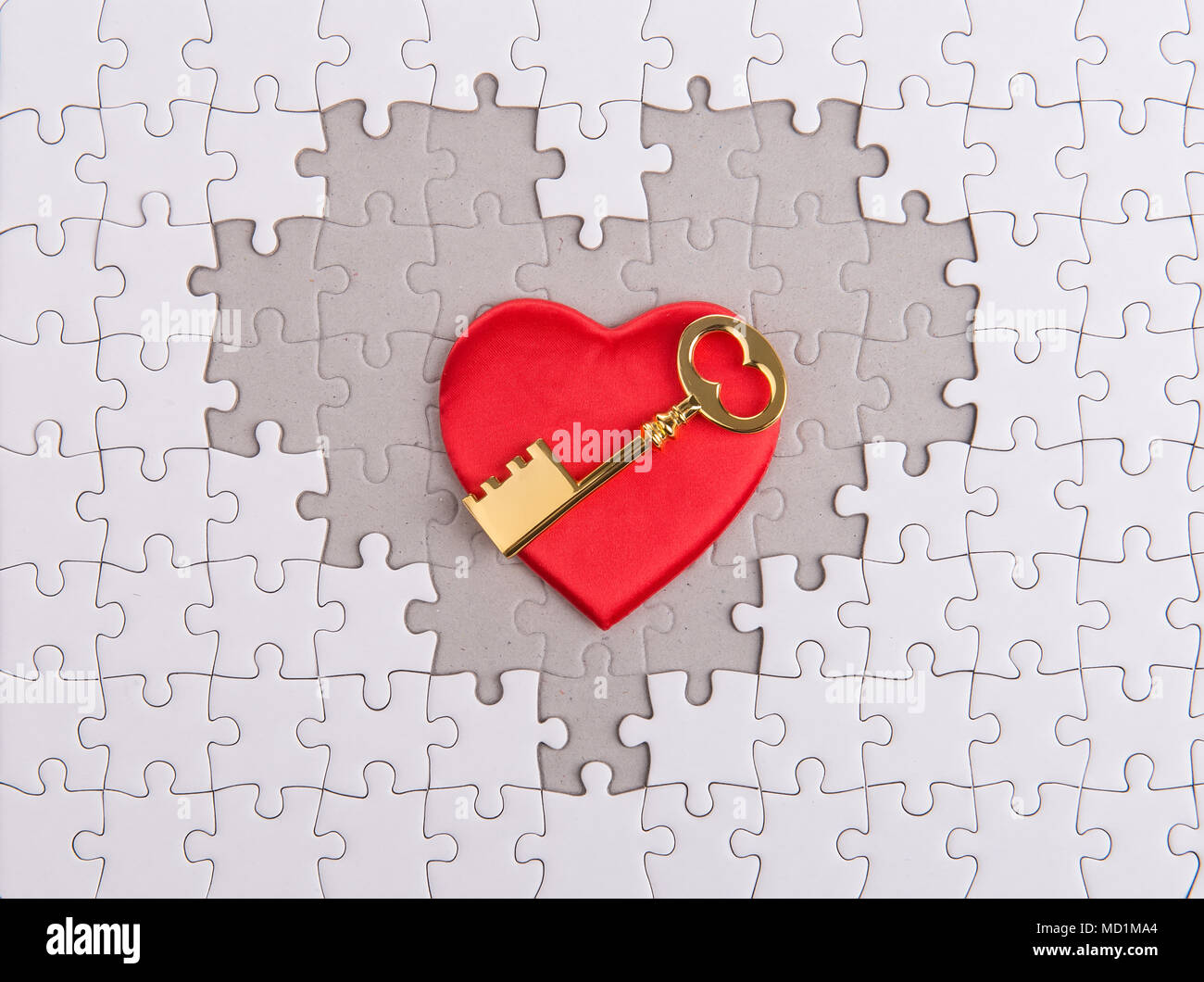 golden Key with heart shape puzzle Stock Photo