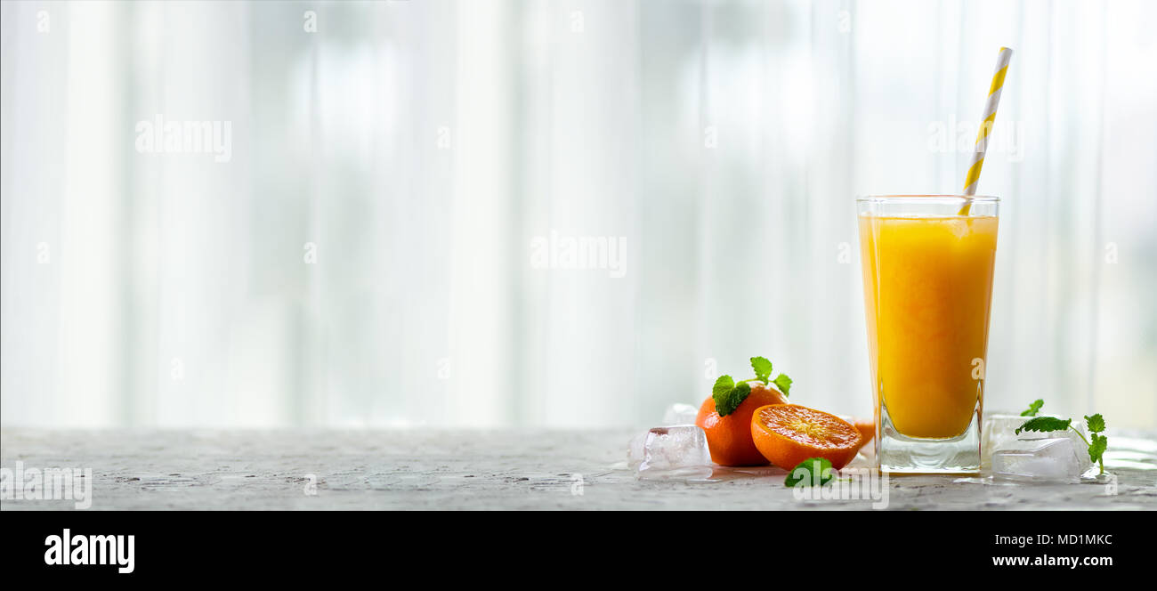 Fresh Tangerine Juice In Glass On White Concrete Background