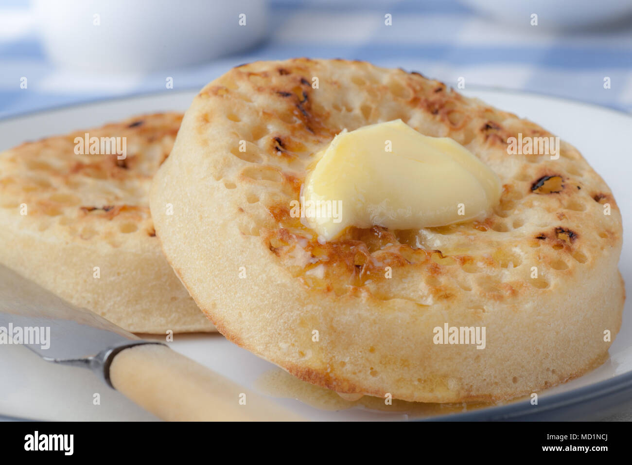 Hot Buttered Crumpets on a plate Stock Photo