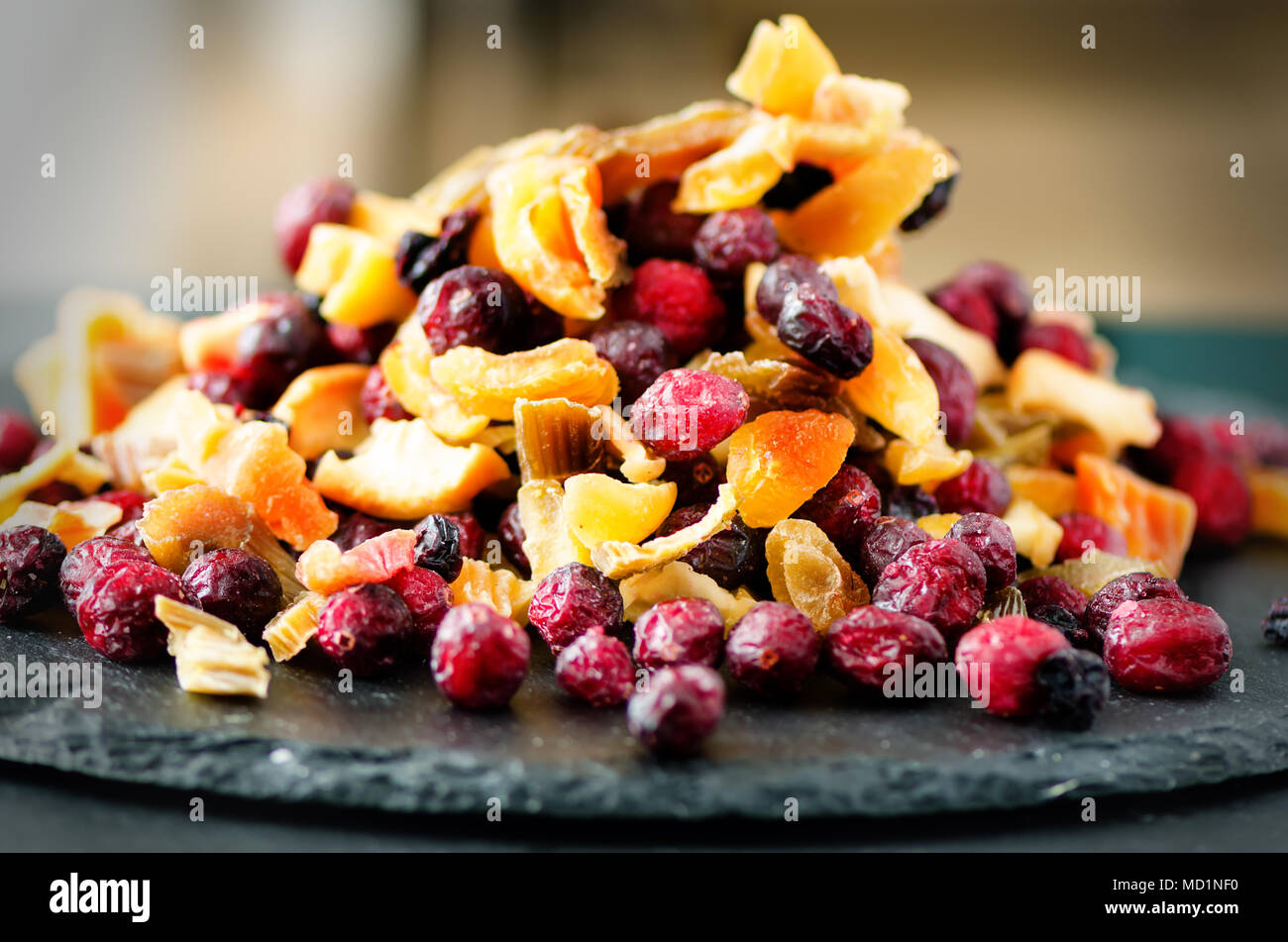Sweet mix dried fruits on stone. Cranberry, rhubarb, apple, mango, cherry, peach, apricot. High dose vitamin C. Colorful background. Stock Photo