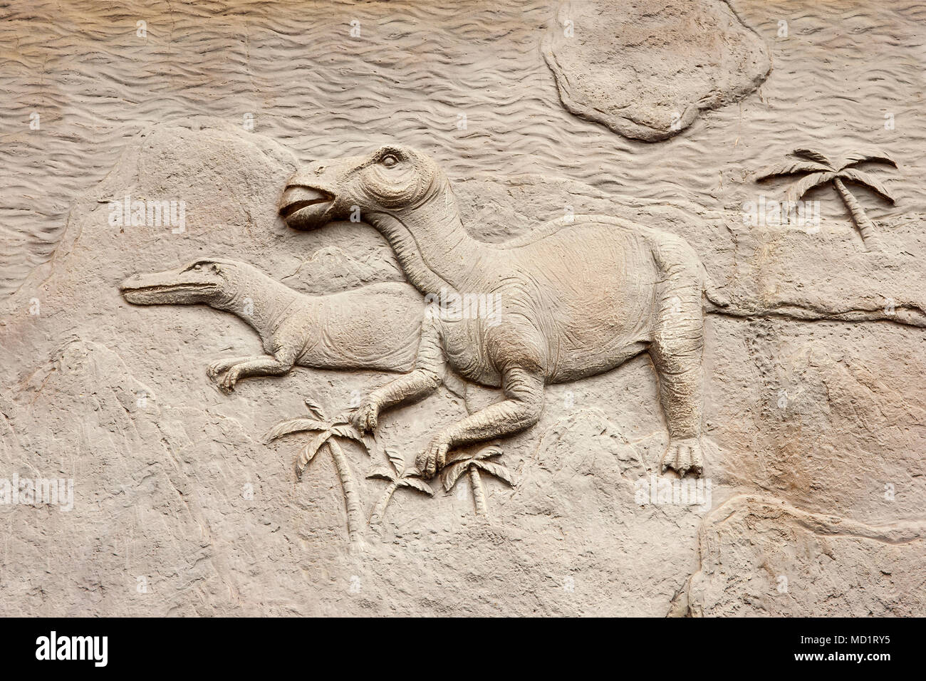 Dinosaurs bas relief on the wall. Stock Photo