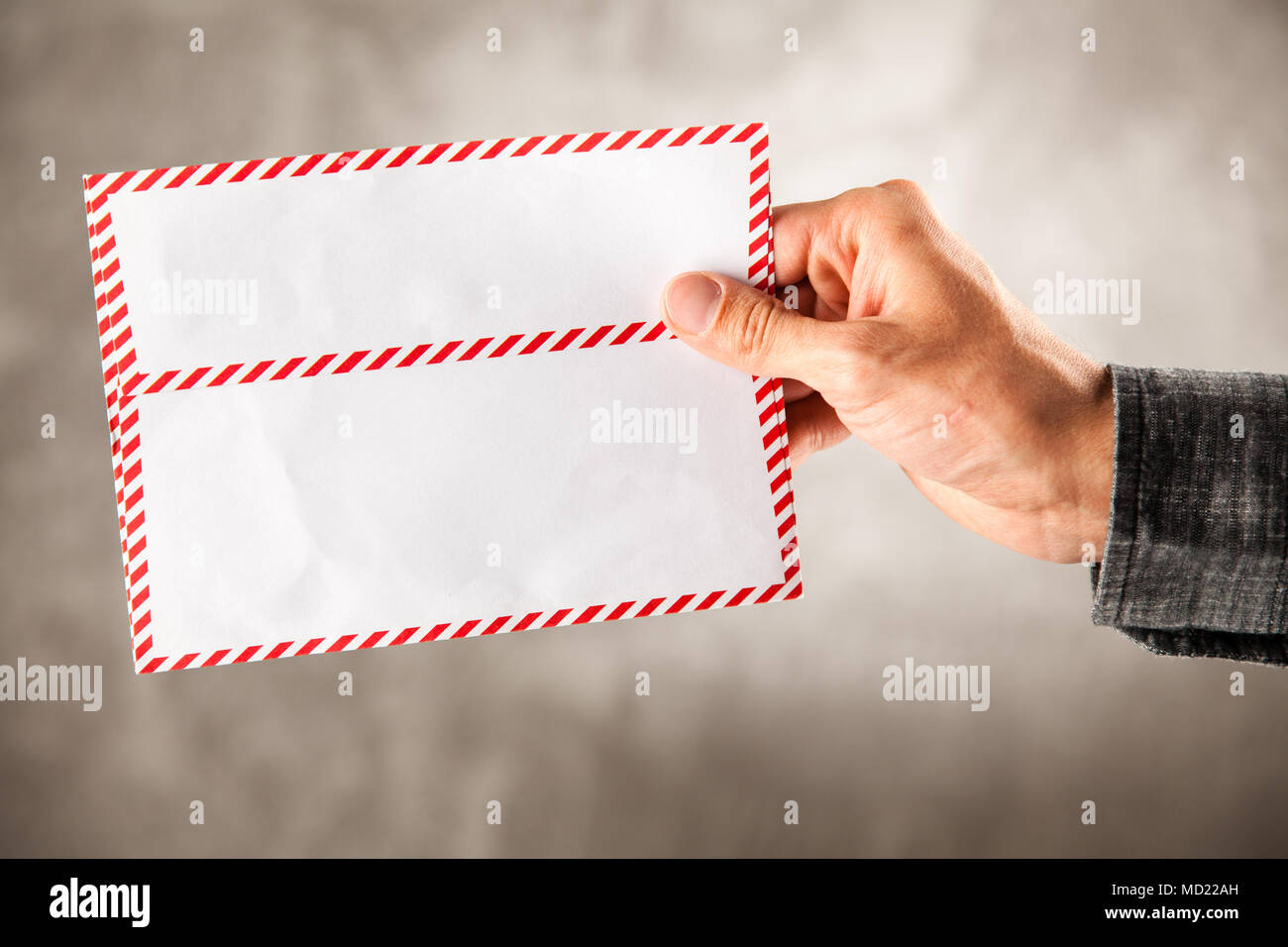 Male hand holding an envelope Stock Photo Alamy