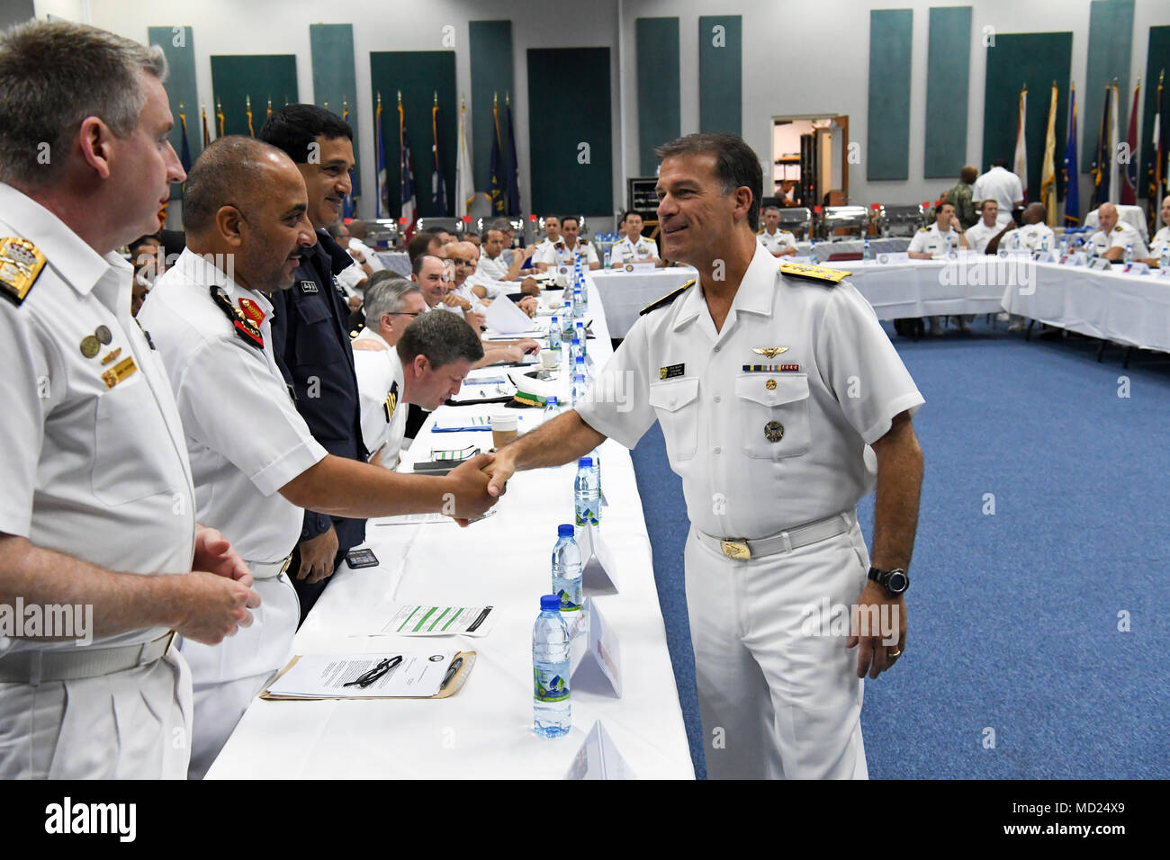 https://c8.alamy.com/comp/MD24X9/180314-n-tb177-0006-manama-bahrain-march-14-2018-commander-us-naval-forces-central-command-vice-adm-chris-aquilino-greets-attendees-at-the-combined-maritime-forces-cmf-commanders-conference-onboard-naval-station-bahrain-the-conference-brought-together-senior-military-leaders-from-more-than-30-nations-to-discuss-maritime-strategy-counter-piracy-and-emerging-threats-in-the-us-5th-fleet-area-of-operations-us-navy-photo-by-mass-communication-specialist-2nd-class-kevin-j-steinbergreleased-MD24X9.jpg