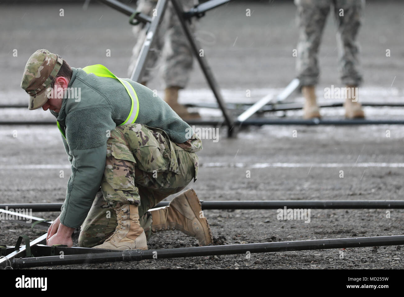 A U.S. Army Reserve Soldier constructs a mobile maintenance tent during Operation Patriot Bandolier at Military Ocean Terminal Concord, California, Mar. 2, 2018. Operation Patriot Bandolier is a real-world strategic mission utilizing U.S. Army Reserve, National Guard and Active component Soldiers transport Army materiel and munitions containers across the U.S.     (U.S. Army photo by Sgt. Eben Boothby) Stock Photo
