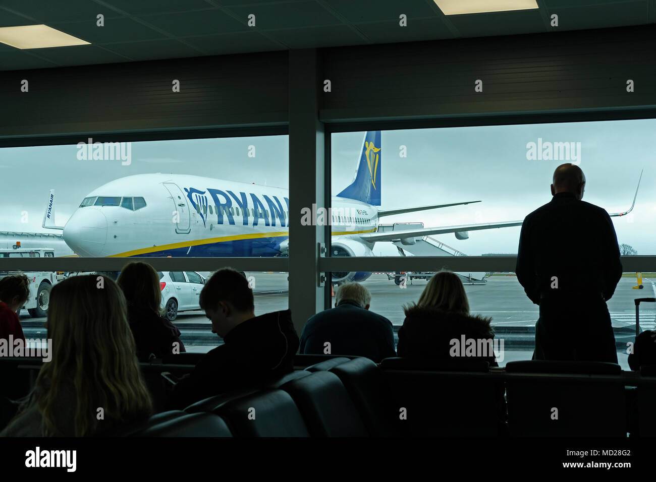 Passengers wait to board a plane at Bristol Airport. Stock Photo