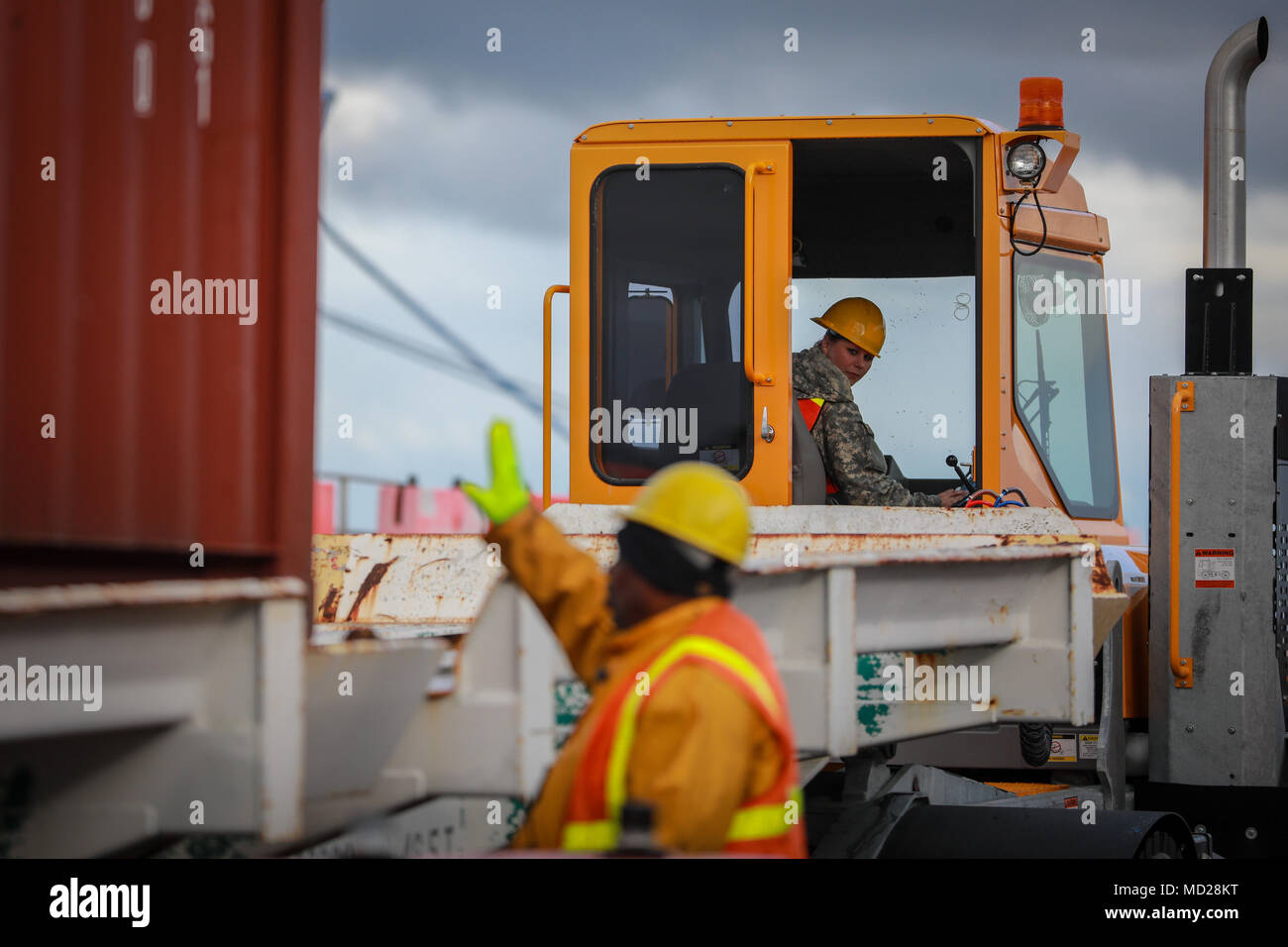 A U.S. Army Reserve Soldier observes the loading of a Twenty-foot equivalent unit container during Operation Trans Mariner 18 West at Military Ocean Terminal Concord, California, Mar. 2, 2018. Trans Mariner 18 West is a real-world strategic mission utilizing U.S. Army Reserve, National Guard and Active component Soldiers to conduct Port Operations allowing Army materiel and munitions containers for travel onward.    (U.S. Army photo by Sgt. Eben Boothby) Stock Photo