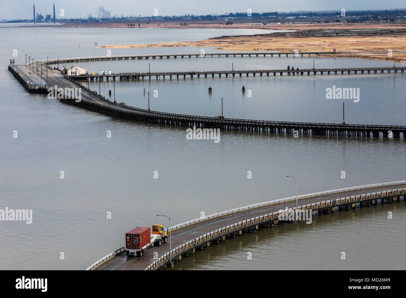 A U.S. Army Reserve Soldier transports a Twenty-foot equivalent unit container across a pier to a staging area during Operation Trans Mariner 18 West at Military Ocean Terminal Concord, California, Mar. 3, 2018. Trans Mariner 18 West is a real-world strategic mission utilizing U.S. Army Reserve and Active component Soldiers to conduct Port Operations allowing Army materiel and munitions containers for travel onward.  (U.S. Army photo by Sgt. Eben Boothby) Stock Photo