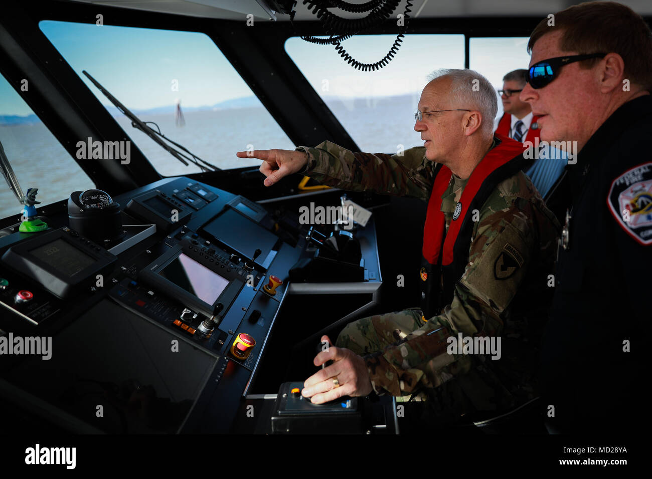Maj. Gen. Allen M. Harrell drives one of two U.S. Army fire boats during Operation Trans Mariner 18 West at Military Ocean Terminal Concord, California, Mar. 6, 2018. Trans Mariner 18 West is a real-world strategic mission utilizing U.S. Army Reserve, National Guard and Active component Soldiers to conduct Port Operations allowing Army materiel and munitions containers for travel onward.    (U.S. Army photo by Sgt. Eben Boothby) Stock Photo
