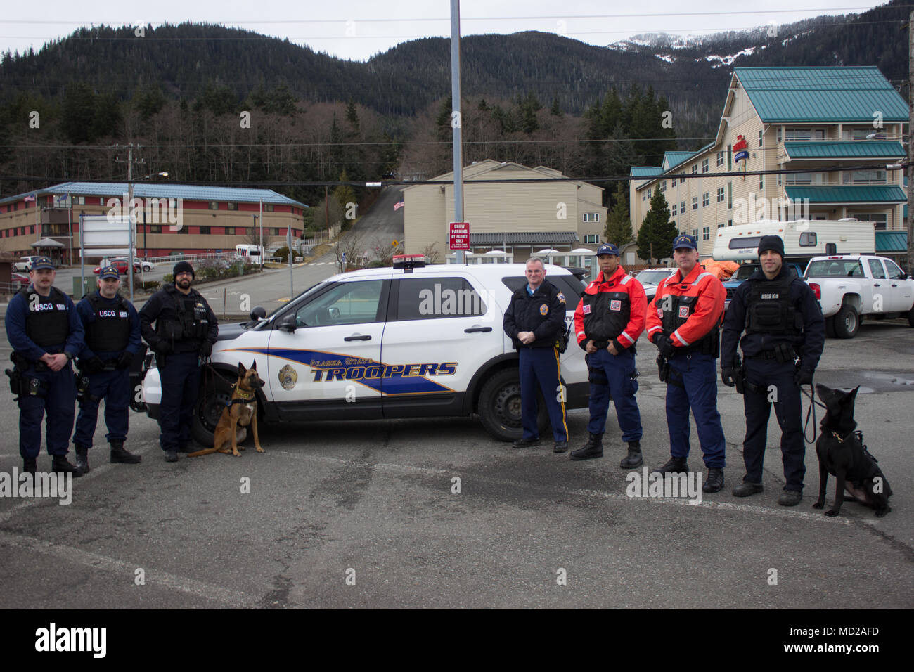 Members of the Coast Guard and Alaska State Troopers pose together following the completion of a joint law enforcement operation at the Alaska Marine Highway System ferry terminal in Ketchikan, Alaska, March 11, 2018. The agencies partnered together during the law enforcement operation to detect and deter illegal activity on Alaska's waterways. U.S. Coast Guard photo by Petty Officer 3rd Class Marissa Gilbert. Stock Photo