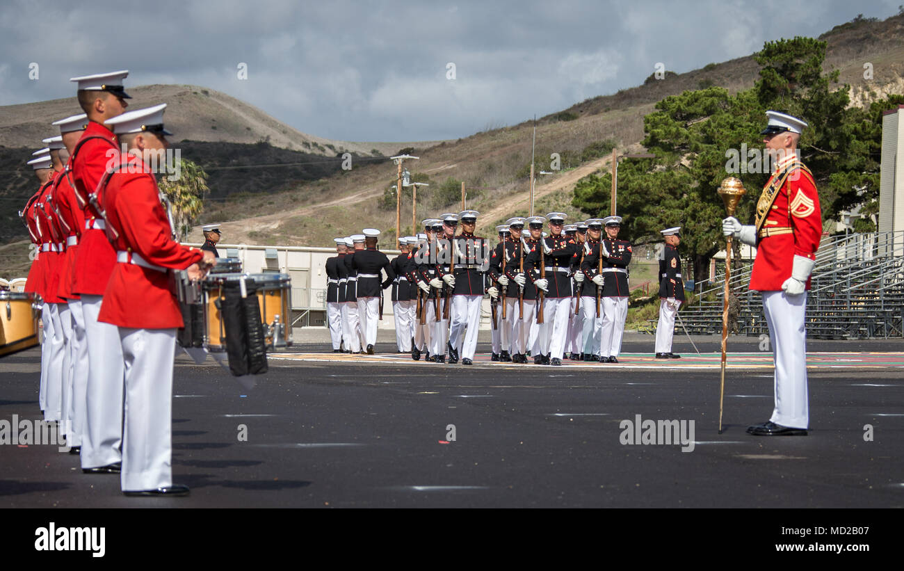 The Silent Drill Platoon, center, and 'The Commandant's Own,' the United States Marine Drum and Bugle Corps, both with the Battle Color Detachment, perform during the Battle Color ceremony at Marine Corps Base Camp Pendleton, Calif., March 15, 2018. The ceremony featured the Drum and Bugle Corps, the Silent Drill Platoon, and the Marine Corps Color Guard. (U.S. Marine Corps photo by Lance Cpl. Rhita Daniel) Stock Photo