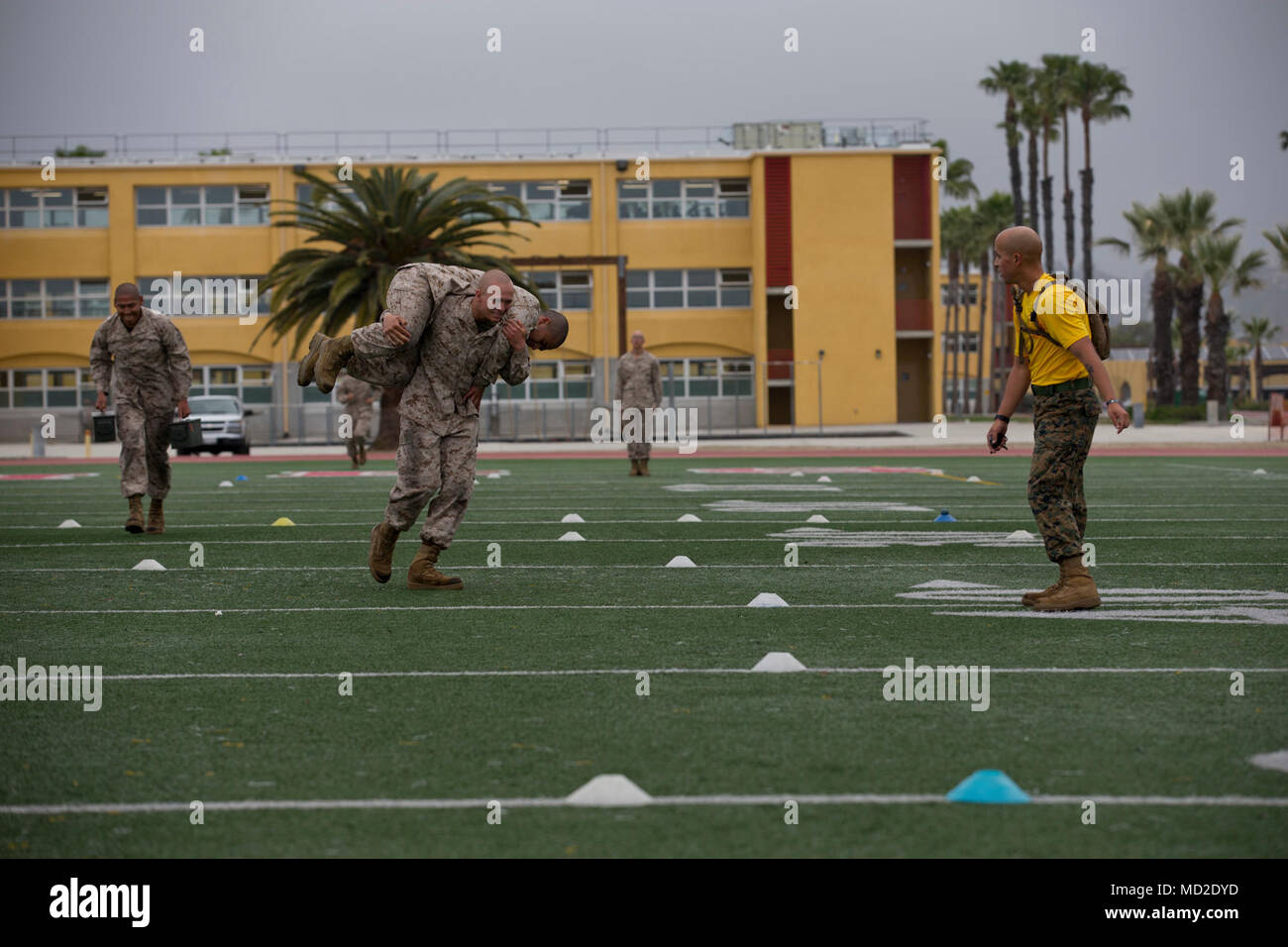 A recruit with Echo Company, 2nd Recruit Training Battalion, performs a fireman’s carry during a combat fitness test at Marine Corps Recruit Depot San Diego, March 23. This is part of the maneuver under fire portion of the event, which simulates carrying a wounded individual in combat. Annually, more than 17,000 males recruited from the Western Recruiting Region are trained at MCRD San Diego. Echo Company is scheduled to graduate May 11. Stock Photo