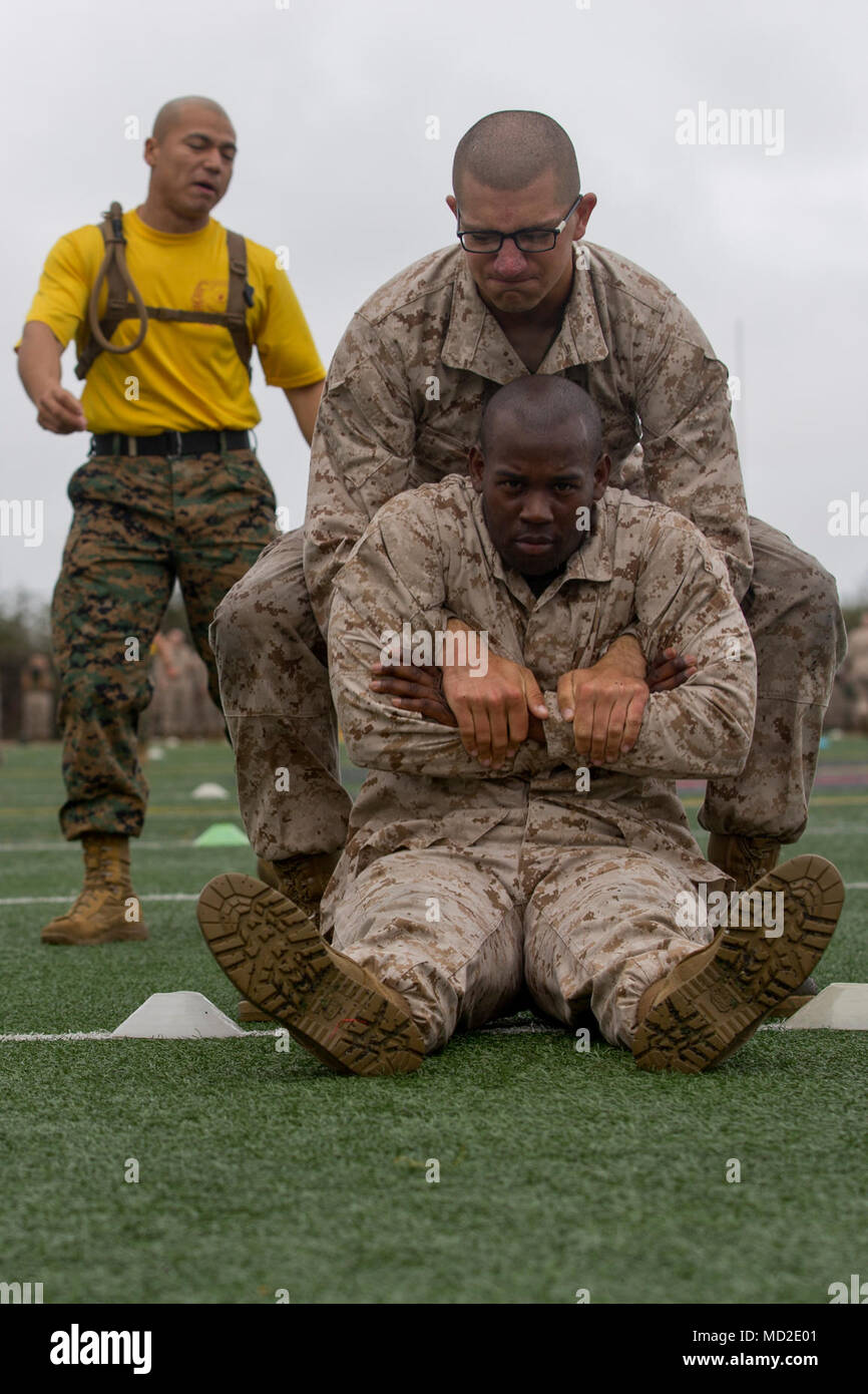 A recruit with Echo Company, 2nd Recruit Training Battalion, buddy drags another recruit during a combat fitness test at Marine Corps Recruit Depot San Diego, March 23. This is part of the maneuver under fire portion of the event, which simulates moving a wounded individual in combat. Annually, more than 17,000 males recruited from the Western Recruiting Region are trained at MCRD San Diego. Echo Company is scheduled to graduate May 11. Stock Photo